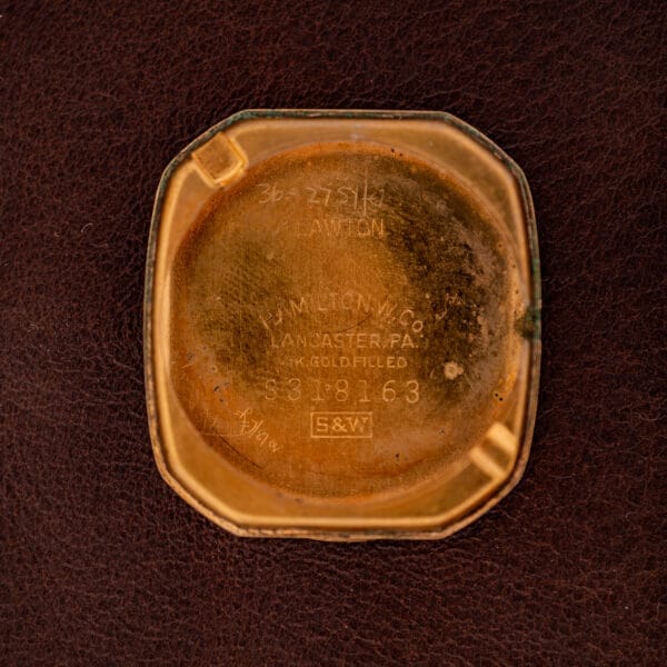 Hamilton Lawton Art Deco Gold Filled Case Manual Wind Cal. 747 features a gold filled case back engraved with Hamilton Watch Co. Lancaster PA, paired with a brown leather strap in classic Art Deco style.