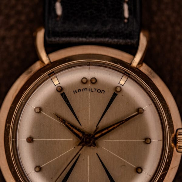 Close-up of a Hamilton K-454 Sputnik Automatic Cal. 661 wristwatch with a gold filled case and black leather strap, displaying the time at 10:09.