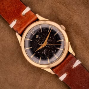 Zodiac Hermetic Caliber 1624 angled on tan suede, gold filled case warm against the black starry-night tropical dial.