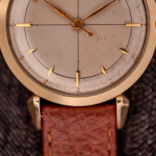 Close-up of a Hamilton Rodney Sector Dial Manual Wind watch (Cal. 748) in a 10k gold filled case, featuring simple tick marks and paired with a brown leather strap.