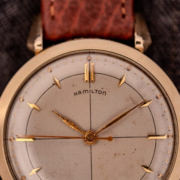 Close-up of a Hamilton Rodney Sector Dial Manual Wind Cal. 748 wristwatch, featuring a 10k gold-filled case and brown leather strap, with elegant gold details on the face and refined sector dial.