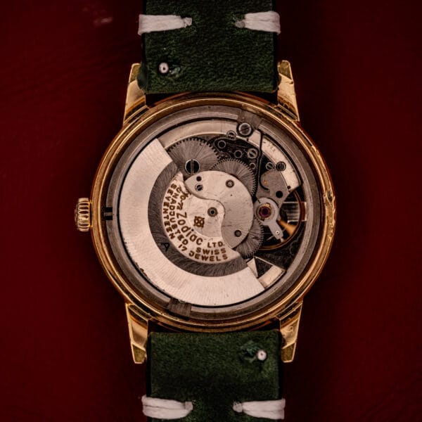 Back view of a Zodiac Hermetic Date Sunburst Dial Ref. 723-917 showcasing its exposed Automatic Cal. 70-72 movement and green leather strap.