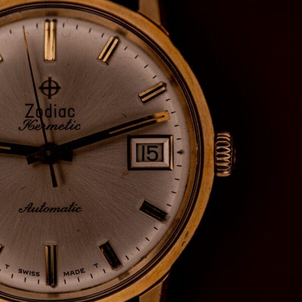 Close-up of a vintage Zodiac Hermetic Date Sunburst Dial Ref. 723-917, featuring an Automatic Cal. 70-72 movement, gold casing and markers, and displaying the date as 15.