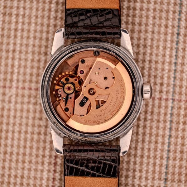 1956 Omega Seamaster Automatic Ref. 2828-6 SC in stainless steel, featuring an exposed Cal. 470 mechanical movement and gears on the back, paired with a black leather strap.