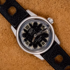Enicar Seapearl 600 Ref. 100/120 stainless steel skin diver on black Tropic rubber strap, glossy starry-night black dial visible from above.