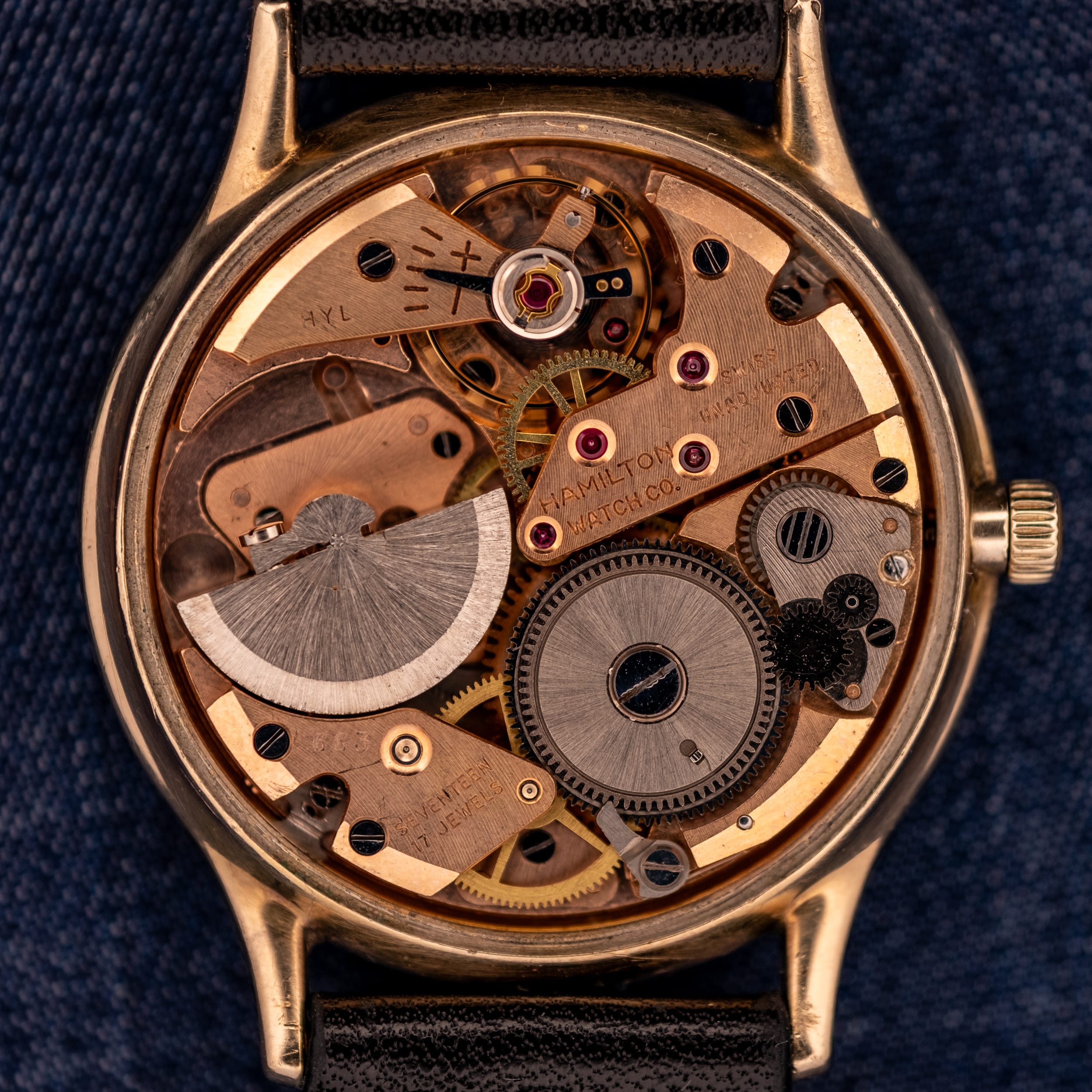 Close-up of a vintage Hamilton watch movement, possibly from a Hamilton CLD or Thin-O-Matic, showcasing visible gears and intricate mechanical parts.