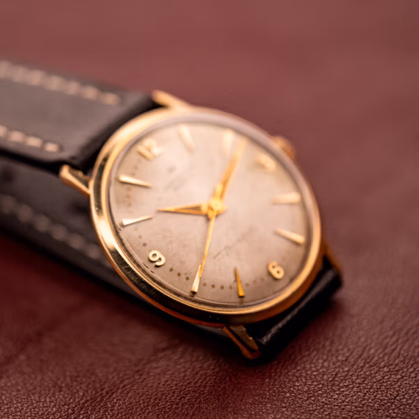 Hamilton Thin-O-Matic three-quarter wrist-style angle, polished 10k gold filled case profile and cream dial with dauphine handset.