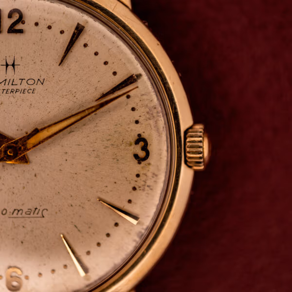 Hamilton Thin-O-Matic detail at three o'clock with signed crown and applied gold baton indices on cream silvered dial.