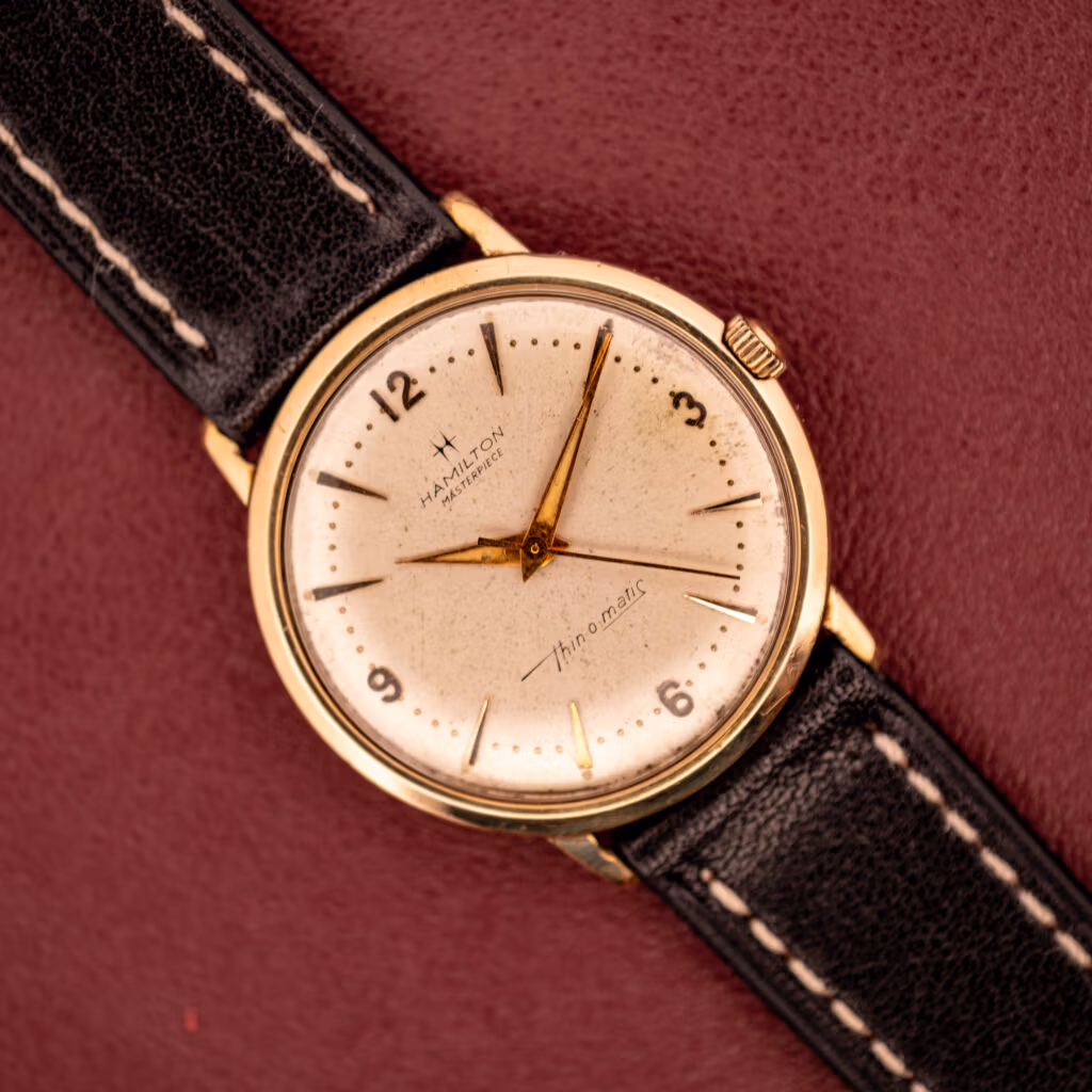 Hamilton Thin-O-Matic Masterpiece on burgundy leather, 10k gold filled case with cream dial and Hamilton Masterpiece signature.