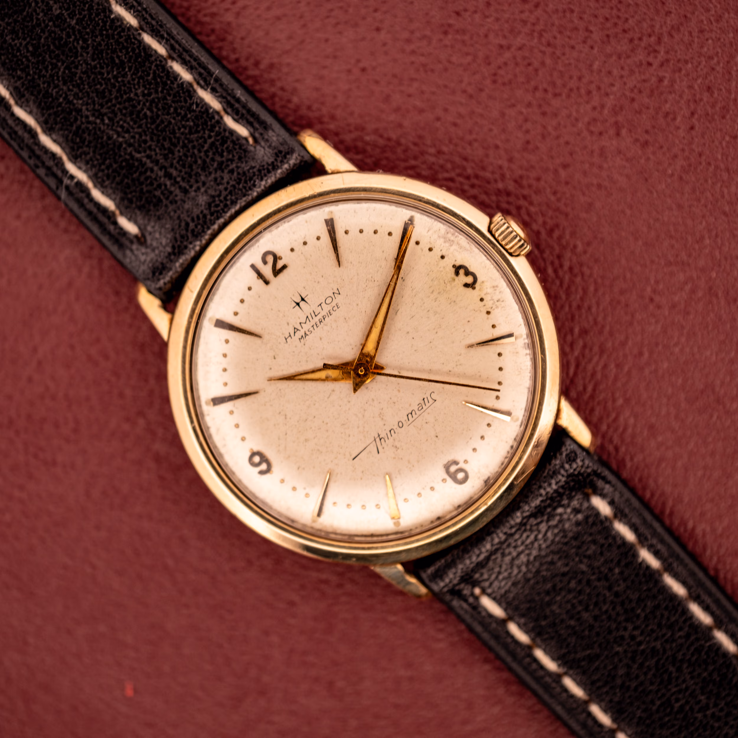 Hamilton Thin-O-Matic Masterpiece on burgundy leather, 10k gold filled case with cream dial and Hamilton Masterpiece signature.