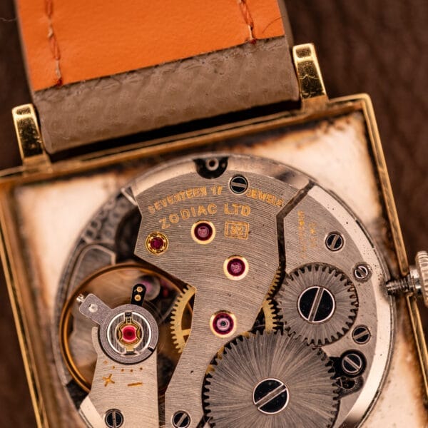 Close-up of the Zodiac Ref. 523-007 Square Case Manual Wind Cal. 52, showcasing its vintage movement with gears, jewels, and engraved text within the distinctive square case.