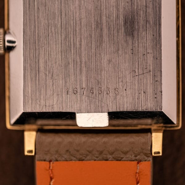 Close-up of a Zodiac Ref. 523-007 Square Case Manual Wind Cal. 52 watch back, engraved with serial number 1674338, featuring a brown leather strap and manual wind movement.
