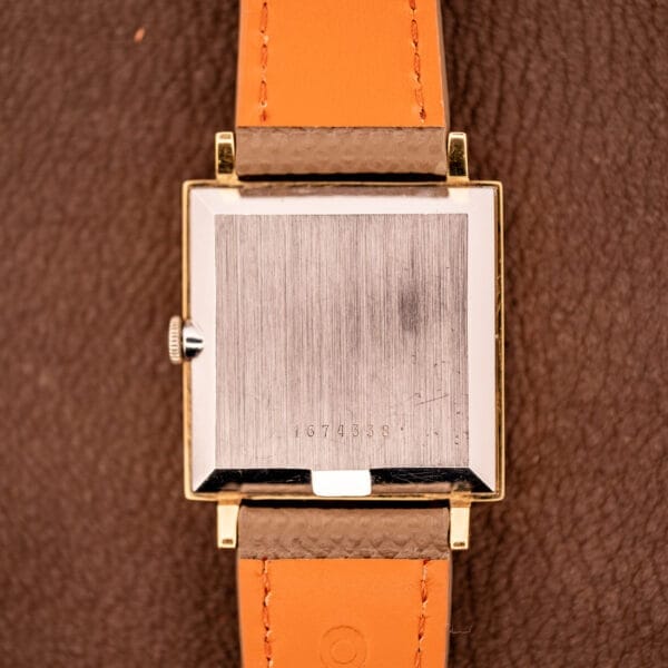 Back of a Zodiac Ref. 523-007 Square Case Manual Wind Cal. 52 wristwatch with an orange leather strap, engraved with the number 1674358.