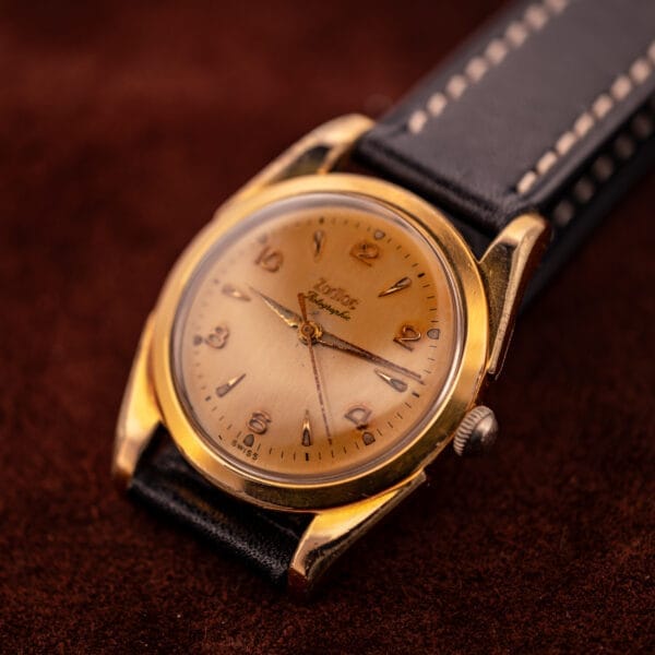 A Zodiac Rotographic Ref. 656 Tropic Dial Automatic Cal. 1381 with a leather strap rests on a brown textured surface.