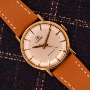 Tissot Seastar Ref. TR 3802 featured shot, cream dial with gilt baton markers, signed crown, gold-plated case on tan leather.
