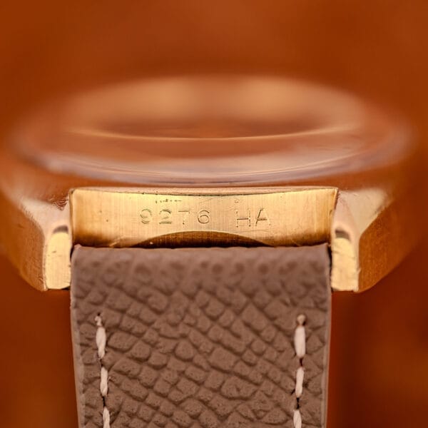 Between-lugs detail of the Girard Perregaux Gyromatic showing the 9276 HA reference number stamped clearly into the case metal at six.