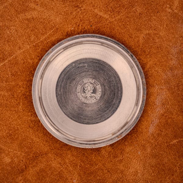 Inner caseback of the GP Gyromatic 9276 HA stamped GIRARD-PERREGAUX SWISS around a crown emblem with concentric machining and watchmaker service marks.