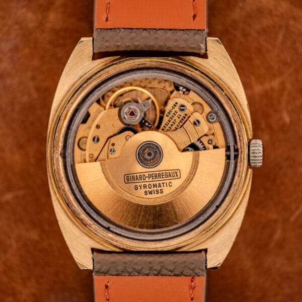 Movement photograph of the Girard Perregaux caliber 480-369 showing the gilt finishing and the Gyromatic-signed rotor reading SWISS across the back.