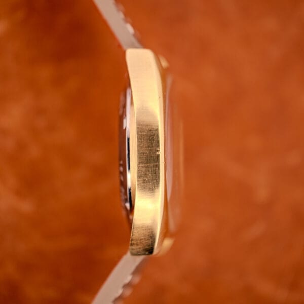 Opposite side profile of the GP Gyromatic showing the brushed gold case sides and the cushion case lug architecture from the opposing direction.