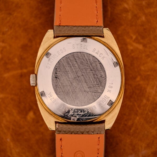 Outer caseback of the GP Gyromatic 9276 HA showing STAINLESS STEEL BACK and 18K GOLD ELECTROPLATE stampings around the snap-on case back.