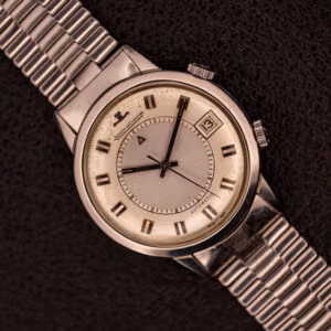 Jaeger-LeCoultre Memovox Ref. E855 in steel on signed NSA bracelet, creamy silver dial with applied steel alarm triangle.