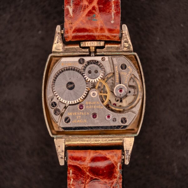 Close-up of an open Gruen "Top Crown" 10K Gold Filled Ref. 400-298 wristwatch, c.1940s, revealing its intricate 17 Jewels gears and mechanical components.
