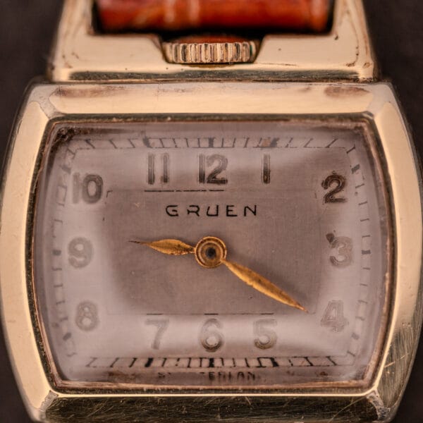 Close-up of a vintage Gruen "Top Crown" 10K Gold Filled 17 Jewels Ref. 400-298 c.1940s wristwatch showing 9:20, featuring a worn face.