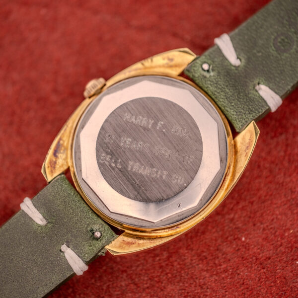 Tissot Seastar Automatic Date Ref. 44660 Cal. 786-2 c.1970s, gold case, green strap, features automatic date; back engraved: “Harry F. Rau, 21 years service, Bell Transit Co.”.