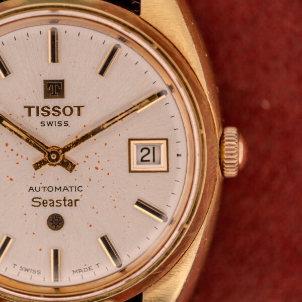 Close-up of a Tissot Seastar Automatic Date Ref. 44660 Cal. 786-2 from the 1970s, featuring a gold case, white dial, automatic date window, and gold markers.