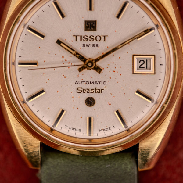 Close-up of a Tissot Seastar Automatic Date Ref. 44660 Cal. 786-2 from the 1970s, showcasing a gold case, green strap, and date display set to 21.