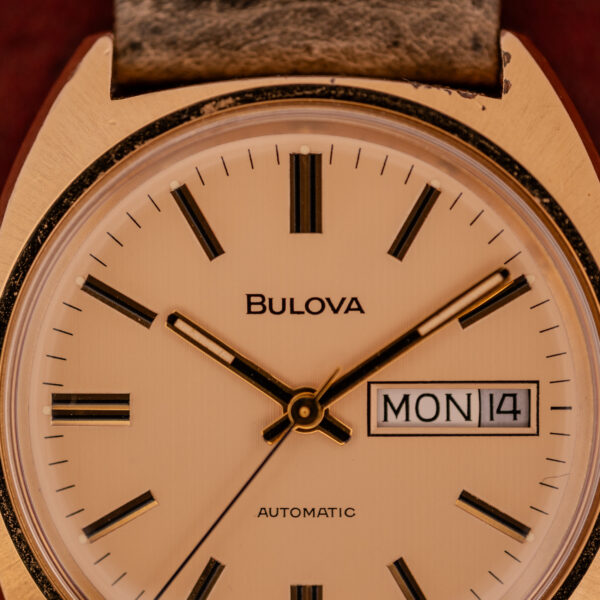 Close-up of a Bulova Automatic Ambassador Day-Date Ref. 7532-1 Cal. 11AOACB c.1970s, displaying the time as 4:27 and Monday the 14th on its dial.