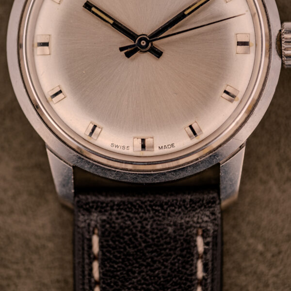 Close-up of a vintage Baume & Mercier Compressor Manual Wind Ref. 1193 Cal. 391 c.1967 wristwatch with Swiss Made on the dial and a black leather strap.