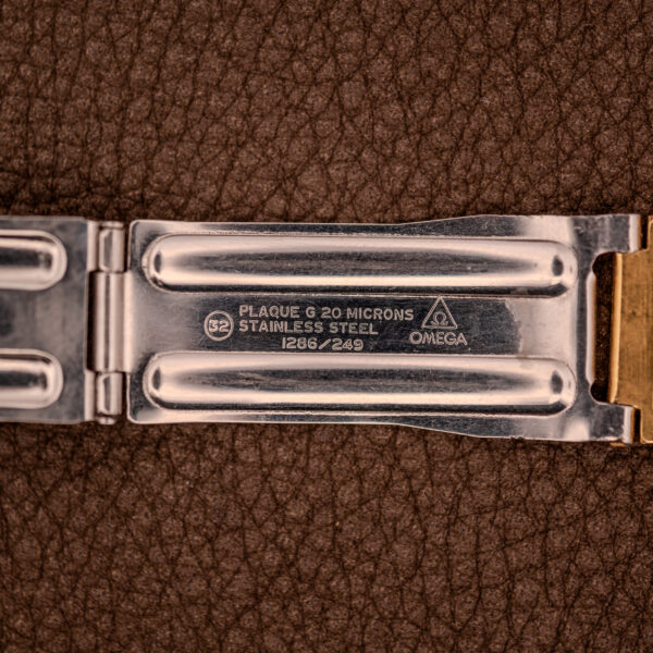 Close-up of an Omega Seamaster Automatic Date "TV Case" Ref. 166.0207 Cal. 1010 stainless steel clasp with engraved details, highlighting the automatic date feature.