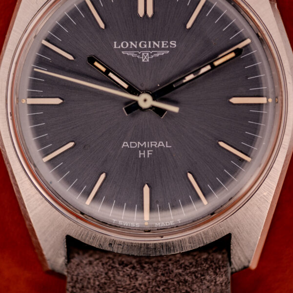 Close-up of the Longines Admiral HF Ref. 2301 (c.1972) featuring an anthracite sunburst dial, silver hour markers, and the Cal. 6942 movement.