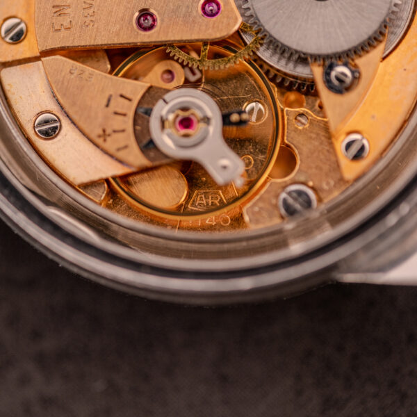 Close-up of the Enicar Sherpa Seapearl 600 Super Compressor Ref. 140/013 Cal. AR 1140, showing vintage mechanical movement with visible gears, screws, and “AR” engraving.