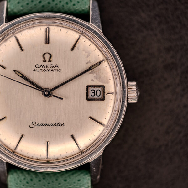 Close-up of an Omega Seamaster Automatic Date Ref. 166.037 (c.1968) with green band, date set to 30, powered by Cal. 565.