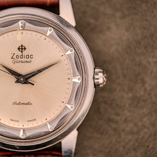 Close-up of a Zodiac Glorious Automatic "Faceted Bezel" Ref. 696 Cal. 1624 wristwatch featuring a cream dial and brown leather strap.