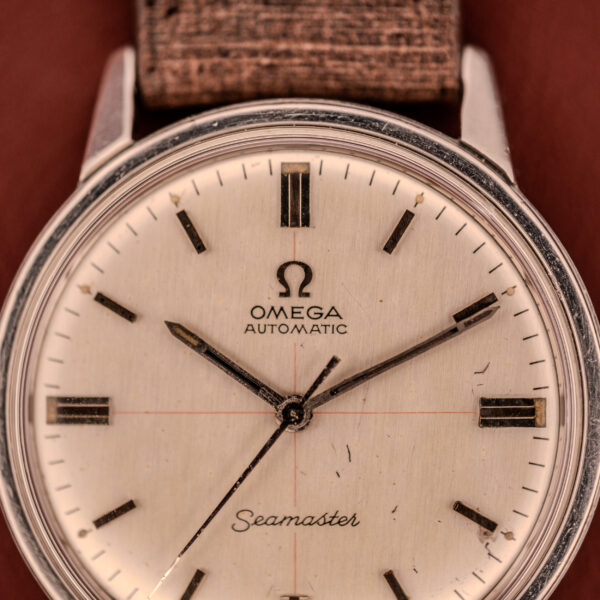 The Omega Seamaster Automatic "Red Crosshair" Ref. 165.002 features the reliable Cal. 552 movement and a distinctive cream dial with black hour markers.