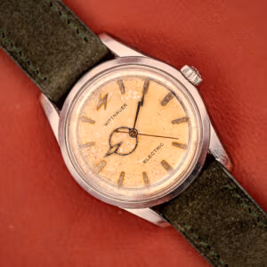 Wittnauer Electro-Chron Ref. 6150/1 top-down view, tropical honey dial, lightning bolt hands, green Italian suede strap.
