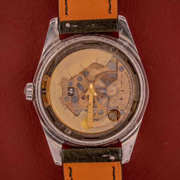 The Wittnauer Electro-Chron "Lightning Bolt" Tropic Dial Ref. 6150 is a vintage wristwatch featuring a transparent case back to reveal its mechanical movement and a distinctive Lightning Bolt seconds hand.