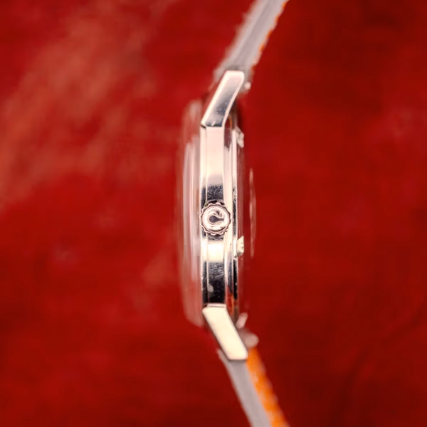 Side profile of Omega Seamaster 165.002 stainless case showing signed Omega crown with Omega symbol at three o'clock