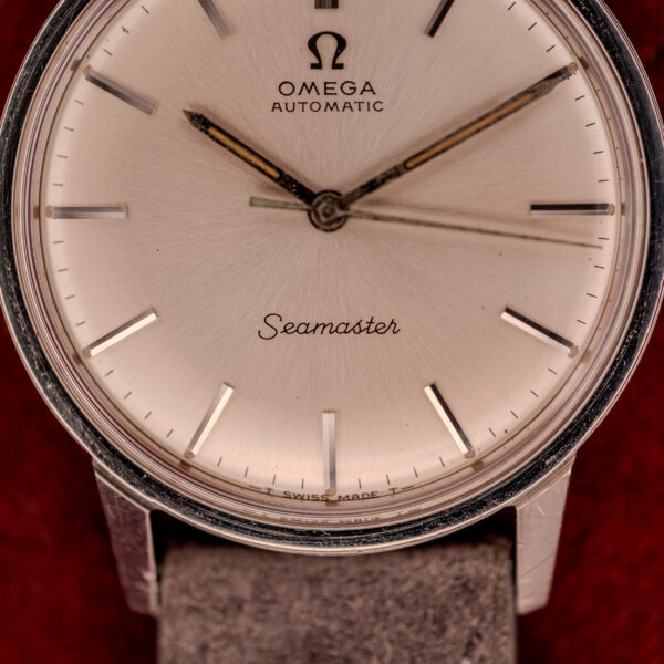 Close-up of an Omega Seamaster Automatic Ref. 165.002, showcasing a silver dial, leather strap, and powered by the respected Cal. 552 movement.