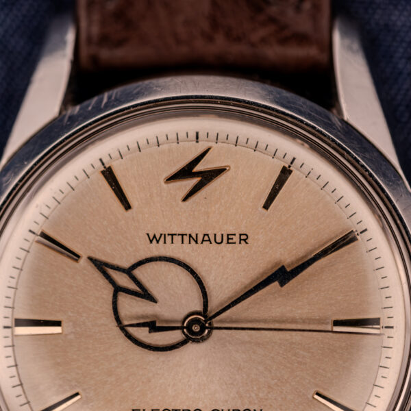 Close-up of a Wittnauer Electro-Chron "Lightning Bolt" Ref. 6150/2 Cal. 11EW c.1962 wristwatch, showcasing its signature lightning bolt dial design and classic brown leather strap.