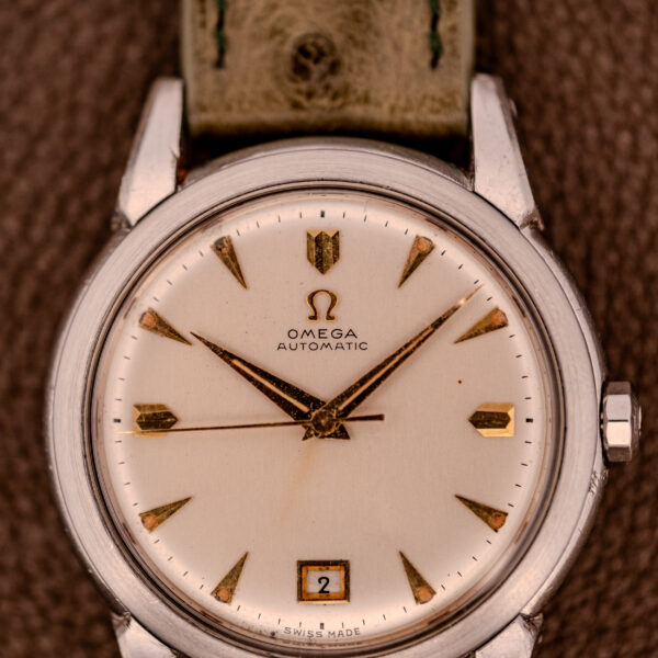 Close-up of an Omega Transitional Calendar Bumper Automatic Ref. 2438-2 Cal. 353 c.1951 wristwatch with a leather strap and date window at 6 o’clock.