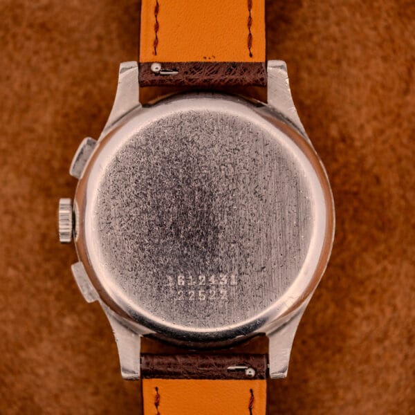 Close-up of the back of a Jaeger Tri-Compax Chronograph Ref. 22522 in stainless steel with a tan leather strap, engraved serial numbers, and classic chronograph detailing.