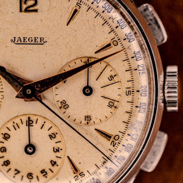 Close-up of a vintage Jaeger Tri-Compax Chronograph Ref. 22522 in stainless steel with Cal. UG 285, featuring an aged dial, visible hands, and subdials.