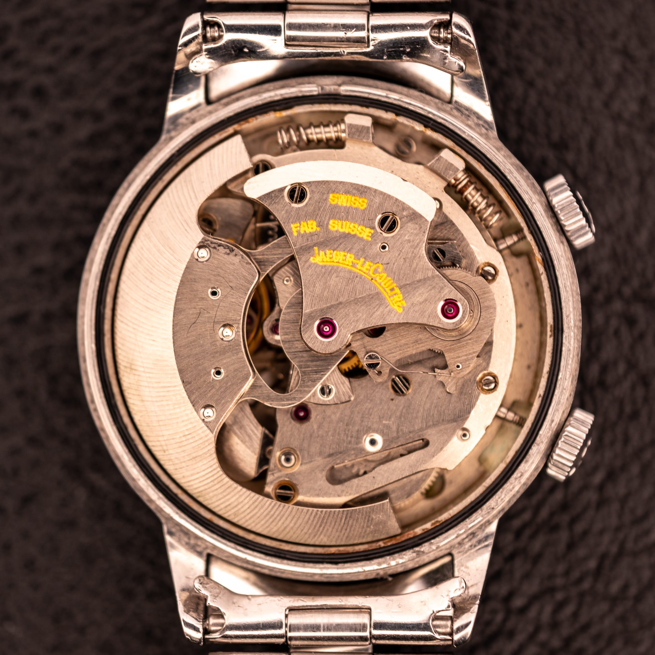 Close-up of an open vintage Jaeger-LeCoultre watch showcasing its intricate inner mechanical parts and classic bumper movement.