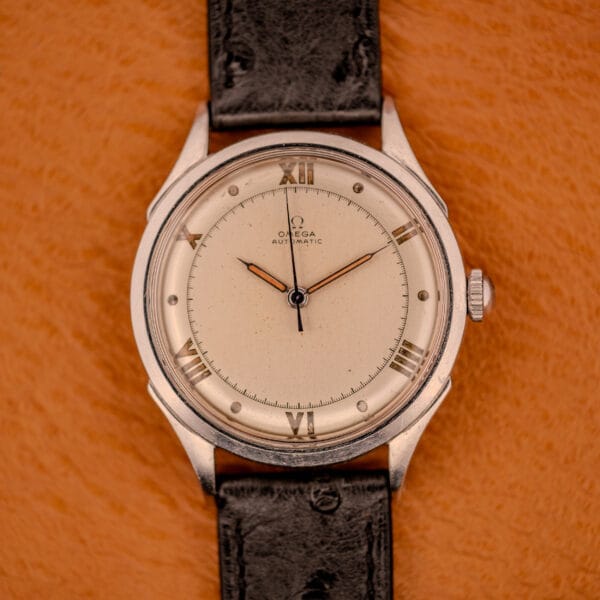 Omega Pre-Seamaster 2584-1 stainless steel cushion case head-on, factory cream dial with applied steel Roman numerals
