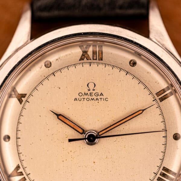 Omega Pre-Seamaster 2584-1 dial macro showing OMEGA AUTOMATIC text, applied logo, and aged dauphine hands