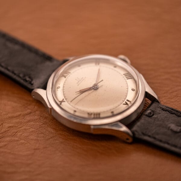 Omega Pre-Seamaster 2584-1 three-quarter perspective showing faceted lug shape and stainless steel cushion case